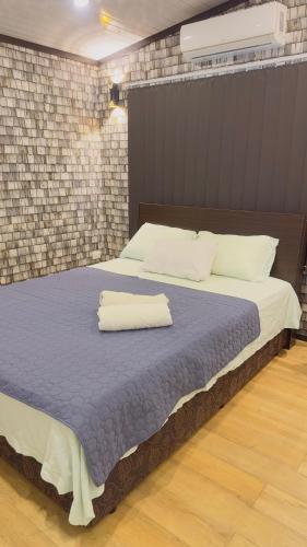 a bedroom with a large bed with two towels on it at Simla 16 in Lautoka