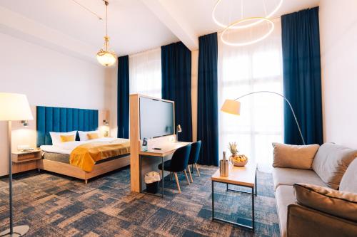 a hotel room with a bed and a couch at H24 Parkhotel Thale in Thale