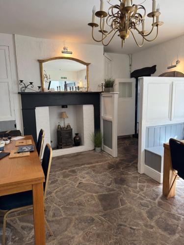 a living room with a table and a fireplace at Castle View Hotel in Chepstow