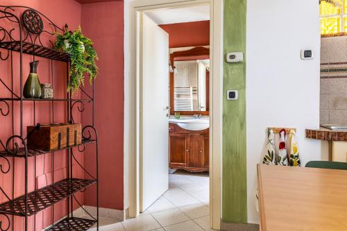 a bathroom with red walls and a sink at Aromatico design 2 camere da letto / centralissimo in Diano Marina