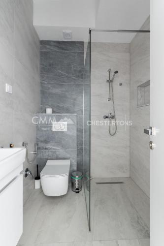 a bathroom with a toilet and a glass shower at Elegant Seaview 1bd in Dobre Vode in Dobra Voda