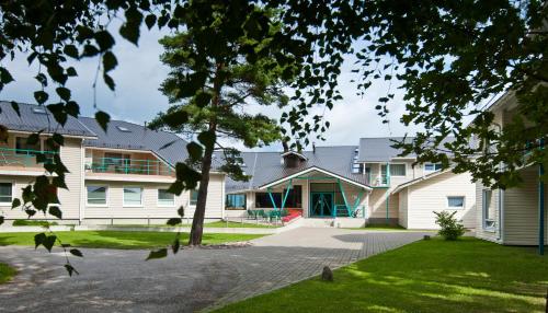 a group of houses with a tree in the foreground at Fra Mare Thalasso Spa in Haapsalu