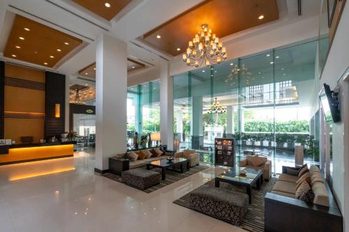 a lobby with couches and tables and a chandelier at Kantary Hotel Kabinburi in Kabin Buri