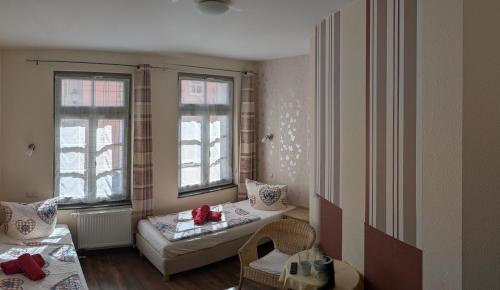 a living room with two windows and a couch at Pension Quartier 11 in Waren