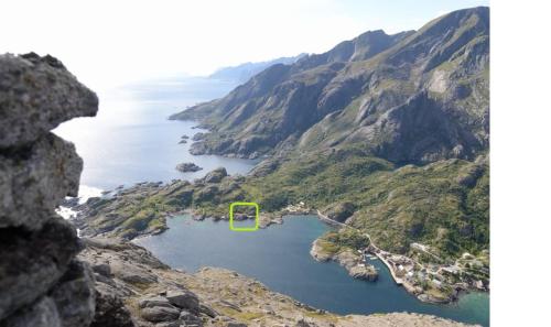 an island in the middle of a body of water at Rorbu in Nusfjord, Lofoten in Nussfjord