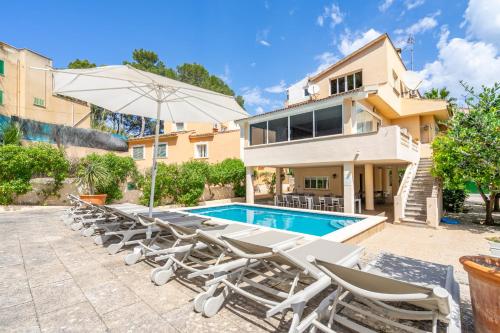 a villa with a swimming pool and lounge chairs at Villa Arenas in El Arenal