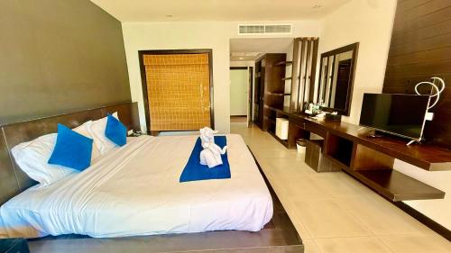 a bedroom with a large bed and a television at APK Resort in Patong Beach