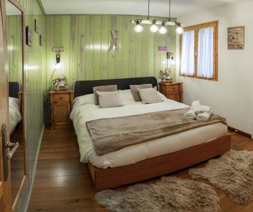 a bedroom with a large bed and green walls at Ibon de Anayet in Formigal