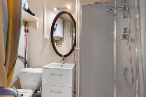 a bathroom with a sink and a mirror at La Cabane du Bassin in Lanton