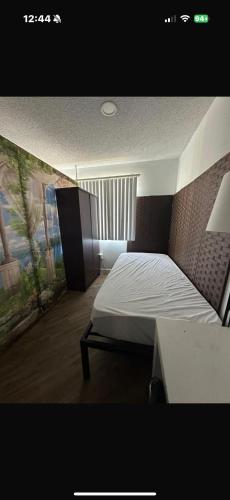 a bedroom with a white bed and a window at Central LA Shared Living #2 in Los Angeles