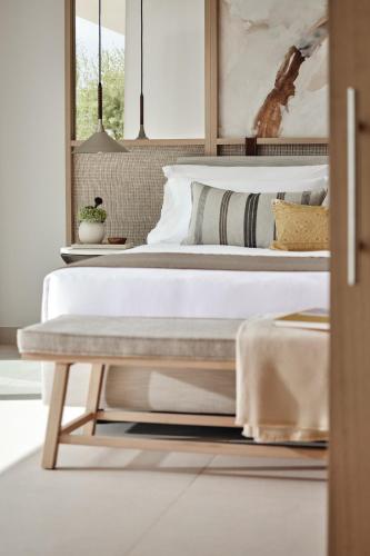 a bedroom with a bed and a table at Ikos Porto Petro in Portopetro