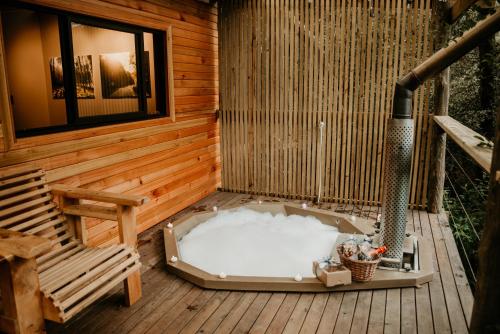 a sauna with a hot tub on a wooden deck at The Cabins Hogsback in Hogsback