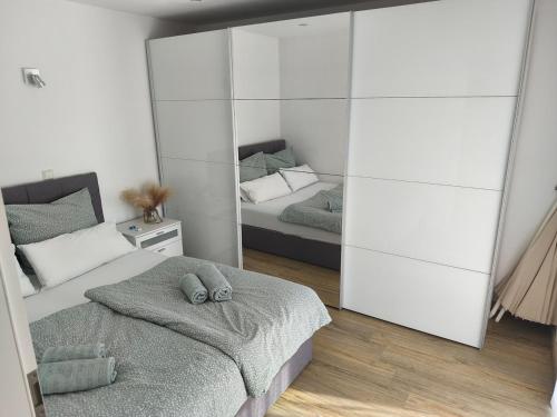 a bedroom with two beds and a mirror at Herdecke, Ruhrperle in Herdecke