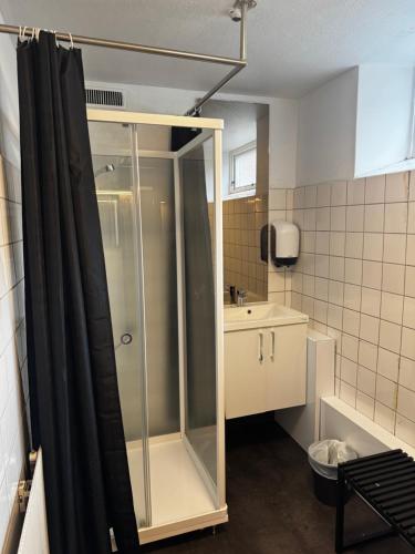 a bathroom with a shower and a sink at Sjømannskirken Narvik in Narvik