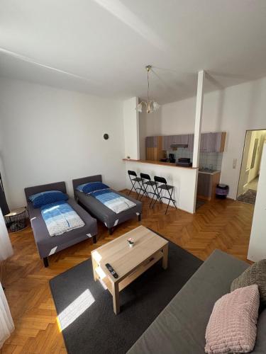 a living room with a couch and a table at Palace Apartment in Vienna