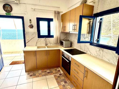 a kitchen with a sink and a stove top oven at Blue Thea in Lentas