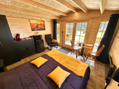 a bedroom with a large bed in a wooden room at ARDENNE CAMPING MABOGE in La-Roche-en-Ardenne