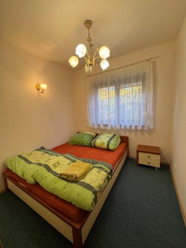 a bedroom with a bed and a window at Domek nad jeziorem Mierzyńskim 50m2 in Mierzyn