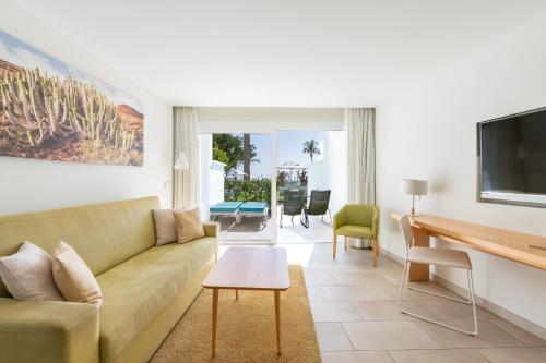 a living room with a couch and a table at Iberostar Selection Lanzarote Park in Playa Blanca