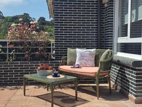 a patio with a table and a chair and a table with a table at Casa El Robledal 5925 in Arnuero