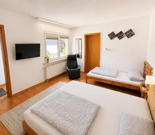 a living room with a bed and a tv at Apartment Hope Inn in Groß-Zimmern