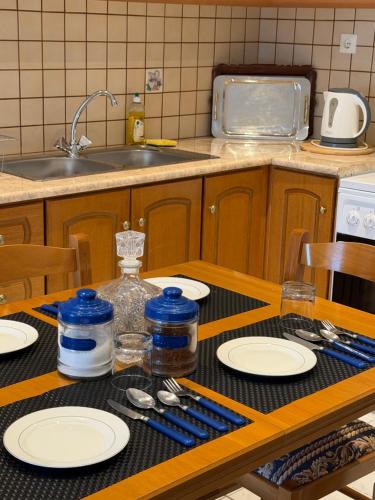 a kitchen with a table with plates and a sink at Panorama House in Pramanta
