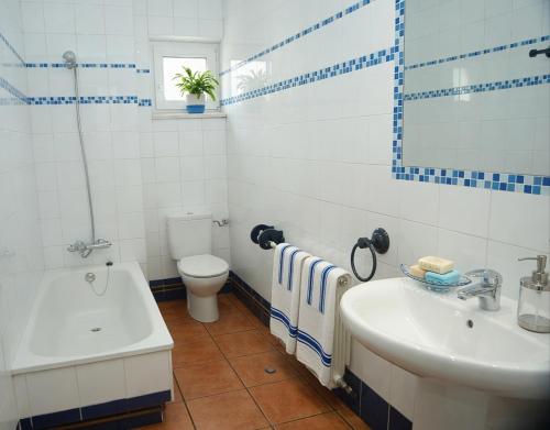 a bathroom with a sink and a tub and a toilet at El Carloto Lanchares in Lanchares