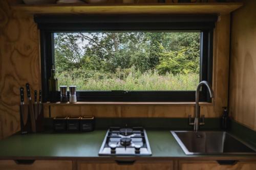 a kitchen with a sink and a window at Adhara in Tarporley