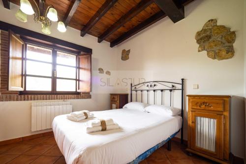 a bedroom with two beds with towels on them at La Helguera By Silastur in Colombres