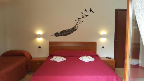 a bedroom with a bed with a pink bedspread at La Casa Dei Sogni in Gallico