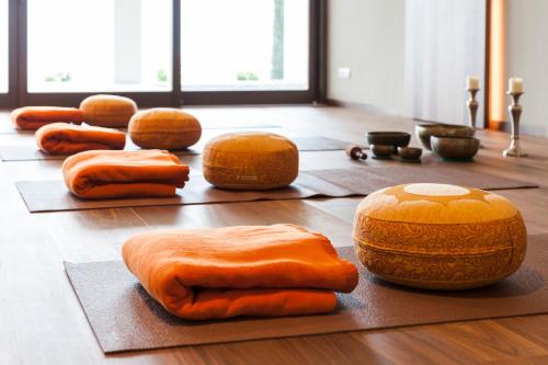 a group of orange hot dogs on a wooden floor at Giardino Marling in Merano
