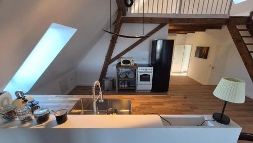 a kitchen with a sink and a refrigerator at Ferienwohnung Melle - Westerhausen in Melle