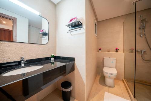 a bathroom with a sink and a toilet and a mirror at Atlantic Blue 3BR Ocean View, Rabat Corniche in Rabat