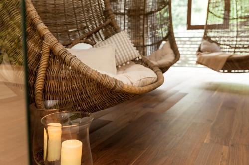a table with candles in a wicker chair with a glass at Giardino Marling in Merano