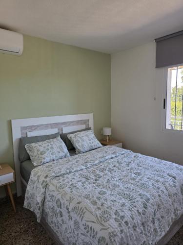 a bedroom with a large bed and a window at Eva luna san juan in Alicante