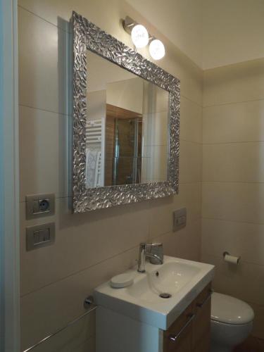 a bathroom with a sink and a mirror at A Casa Di Lucia in Rome