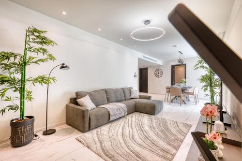 a living room with a couch and a table at 6BR luxury villa with Pool & Hot tub - 2Living rooms & 10Bathrooms in Tal-Għoqod
