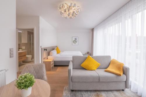 a living room with a couch and a bed at Hotel Krone in Pforzheim