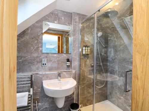 a bathroom with a sink and a shower at Post Cottage in Arisaig