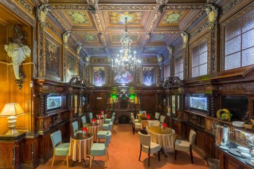 an ornate room with tables and chairs and a chandelier at Big Marine in Saint Petersburg