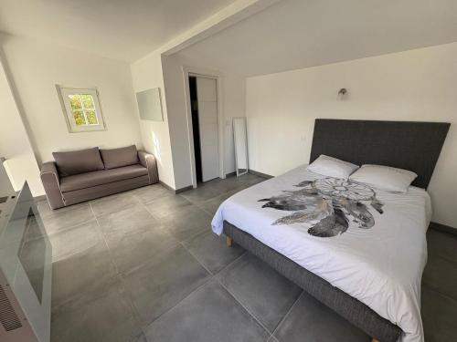 a bedroom with a bed and a couch in it at Maison entière in Dax