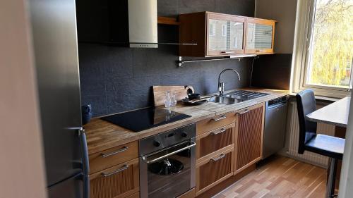 a small kitchen with a sink and a stove at Centrumnära in Gothenburg