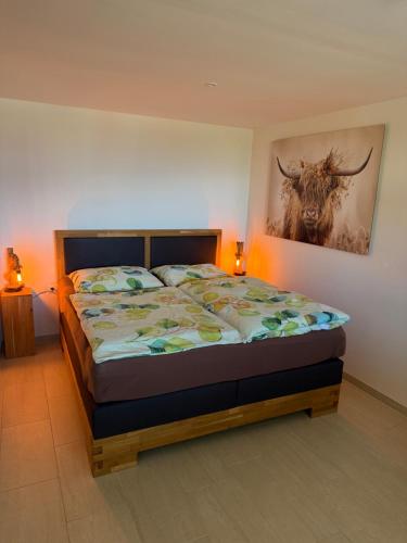 a bedroom with a bed with a picture of a bull on the wall at Schönblick in Oberaichwald