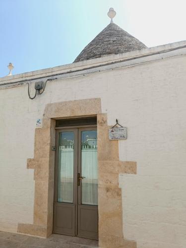 a building with a door with a sign on it at Trulli Soave in Alberobello