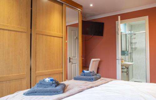 a bedroom with two towels on a bed at Skeabost View in Tole