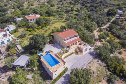 an aerial view of a house with a swimming pool at Villa Florencio by Algarve Holidays in Estói