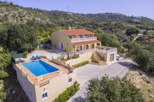 an aerial view of a house with a swimming pool at Villa Florencio by Algarve Holidays in Estói