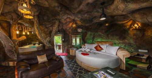 a room with a large bed in a rock wall at Parakkat Nature Resort in Munnar
