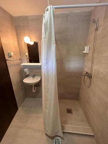 a bathroom with a shower and a sink at Hotel Andrićgrad in Višegrad