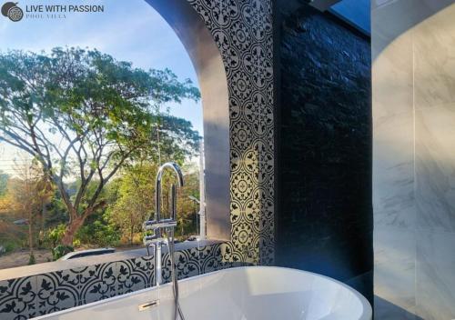 a bathroom with a sink and a window at Live With Passion Pool Villa in Pak Chong
